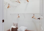 Thumbnail 9 of 19 - a closet with a chair and a rack with clothes on it at The Olivine, Austin