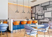 Thumbnail 15 of 19 - a restaurant with blue chairs and a counter with orange chairs at The Olivine, Austin, Texas