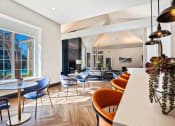 Thumbnail 14 of 19 - a dining room with tables and chairs and a large window at The Olivine, Austin