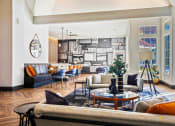 Thumbnail 12 of 19 - a living room with couches and a table at The Olivine, Texas