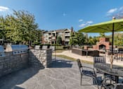 Thumbnail 21 of 38 - Outdoor grilling station with stone masonry at Wyndchase Aspen Grove Apartments, Tennessee, 37067