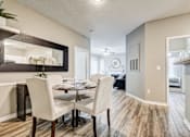 Thumbnail 7 of 38 - Dining area with modern furnishings and hallway at Wyndchase Aspen Grove Apartments, Franklin, TN 37067