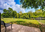 Thumbnail 28 of 38 - Fenced dog park with bench and exercise equipment at Wyndchase Aspen Grove Apartments, Tennessee