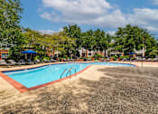 Thumbnail 17 of 38 - Outdoor swimming pool with red brick trim at Wyndchase Aspen Grove Apartments, Franklin, TN