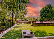 Thumbnail 24 of 38 - Putting green with cornhole game and landscaping at Wyndchase Aspen Grove Apartments, Franklin, 37067