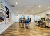 Thumbnail 15 of 38 - A spacious room with wooden floors and a bar area.
