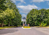 Thumbnail 35 of 38 - Clock tower entrance monument surrounded by trees at Wyndchase Aspen Grove Apartments, Tennessee