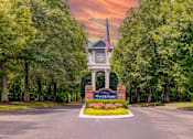 Thumbnail 34 of 38 - Property entrance monument with flagpole and landscaping at Wyndchase Aspen Grove Apartments, Tennessee, 37067