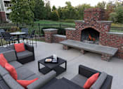 Thumbnail 22 of 38 - Brick outdoor fireplace with built in seating benches at Wyndchase Aspen Grove Apartments, Tennessee
