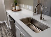 Thumbnail 2 of 38 - Undermount sink with pulldown faucet and white countertop at Wyndchase Aspen Grove Apartments, Franklin, TN 37067