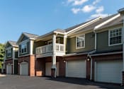 Thumbnail 31 of 38 - Two story apartment garages with balconies and brick accents at Wyndchase Aspen Grove Apartments, Franklin, 37067