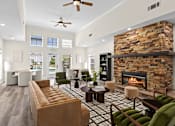 Thumbnail 13 of 33 - A living room with a fireplace and a couch.