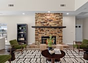 Thumbnail 14 of 33 - A living room with a fireplace and a black and white tiled floor.