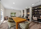 Thumbnail 18 of 33 - A dining room with a wooden table and chairs.