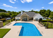 Thumbnail 2 of 33 - A large house with a pool in the backyard.