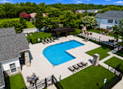 Thumbnail 4 of 33 - A large swimming pool surrounded by a black fence and lounge chairs.