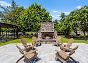 Thumbnail 8 of 33 - A set of four chairs are arranged around a fire place.