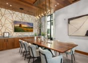 Thumbnail 17 of 40 - a dining room with a wooden table and chairs at The Colony, Charlotte, 28211