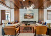Thumbnail 22 of 40 - a living room with couches and chairs and a fireplace at The Colony, Charlotte, NC