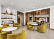 Thumbnail 23 of 40 - the lobby of a hotel with yellow chairs and tables at The Colony, Charlotte, NC, 28211