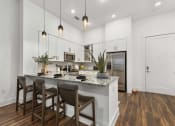 Thumbnail 3 of 40 - a kitchen with a large island with three stools at The Colony, Charlotte, 28211