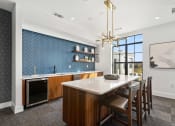 Thumbnail 19 of 40 - a kitchen with a large island and a dining table with chairs at The Colony, Charlotte, NC, 28211