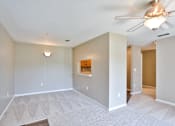 Thumbnail 17 of 17 - A room with a ceiling fan and a light fixture.