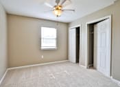 Thumbnail 9 of 17 - A room with a ceiling fan and a window.