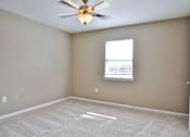 Thumbnail 15 of 17 - A room with a ceiling fan and a window.