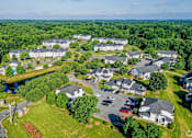 Thumbnail 2 of 17 - A bird's eye view of a residential area with houses and a river.