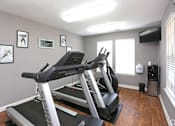 Thumbnail 19 of 19 - A treadmill in a room with a grey wall and a window.