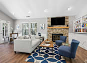Thumbnail 17 of 19 - A living room with a fireplace and a couch.