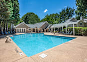 Thumbnail 18 of 19 - A large swimming pool in front of a house.