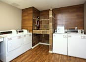 Thumbnail 18 of 19 - A laundry room with a washer and dryer in it.