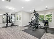 Thumbnail 5 of 17 - A spacious home gym with a variety of equipment.