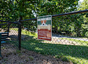Thumbnail 8 of 17 - A sign on a fence that says Dog Park Rules.