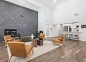 Thumbnail 7 of 17 - A living room with a fireplace and a grey wall.