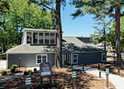 Thumbnail 10 of 17 - A leasing center is located in a wooded area.
