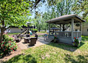Thumbnail 29 of 31 - A gazebo is surrounded by a lawn and trees.