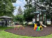 Thumbnail 9 of 31 - a playground in a park on a sunny day