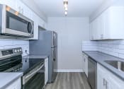 Thumbnail 12 of 17 - a kitchen with stainless steel appliances and white cabinets at Tides at Mesa, Mesa, AZ, 85204