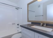 Thumbnail 14 of 17 - a bathroom with a sink and a toilet and a mirror at Tides at Mesa, Mesa, Arizona