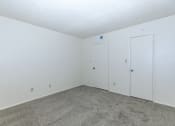 Thumbnail 18 of 19 - an empty room with carpet and white doors at Tides on Southern, Arizona, 85204