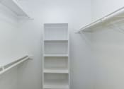Thumbnail 12 of 19 - an empty closet in a room with white walls and shelves at Tides on Southern, Mesa, AZ