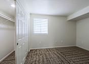Thumbnail 10 of 16 - A room with a white door and a window with blinds.
