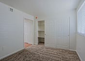 Thumbnail 9 of 16 - A room with a carpeted floor and a white door.