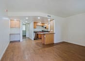 Thumbnail 3 of 16 - A kitchen with wooden cabinets and a countertop is visible.