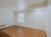 Thumbnail 4 of 16 - A room with a white door and a window with blinds.
