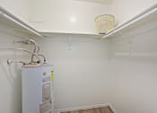 Thumbnail 13 of 13 - a laundry room with a washer and dryer and a shelf with a basket on top