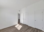Thumbnail 5 of 14 - an empty room with white walls and wood floors